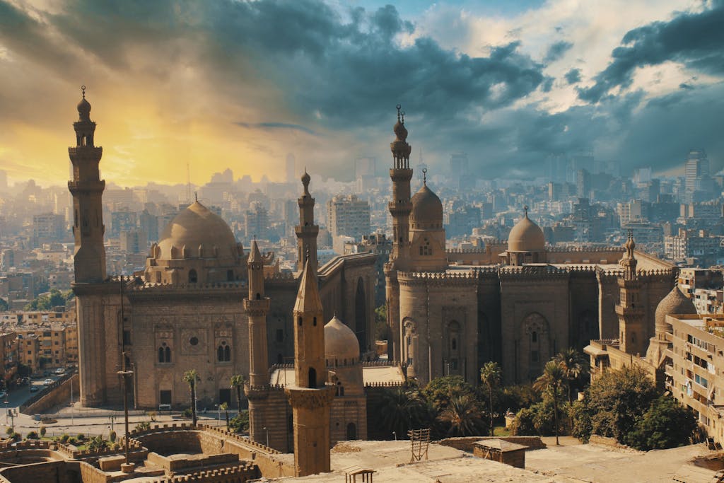 A breathtaking aerial shot of Cairo's historic mosques and cityscape at sunrise.