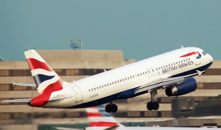 A British Airways aircraft takes off, showcasing aviation and travel themes.