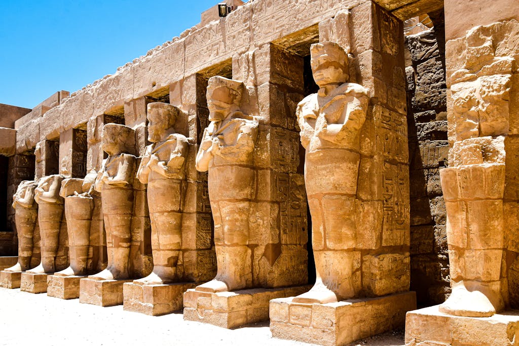 Ancient statues at the Temple of Khonsu in Luxor, showcasing Egyptian architectural brilliance.