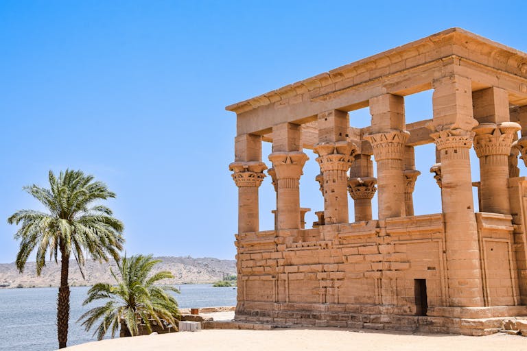 Explore the majestic ruins of an ancient temple by the Nile in Aswan, Egypt.