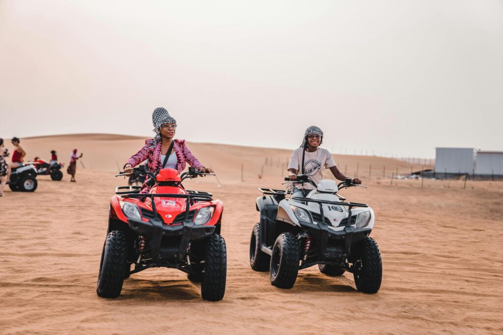 mother and son riding quads on desert