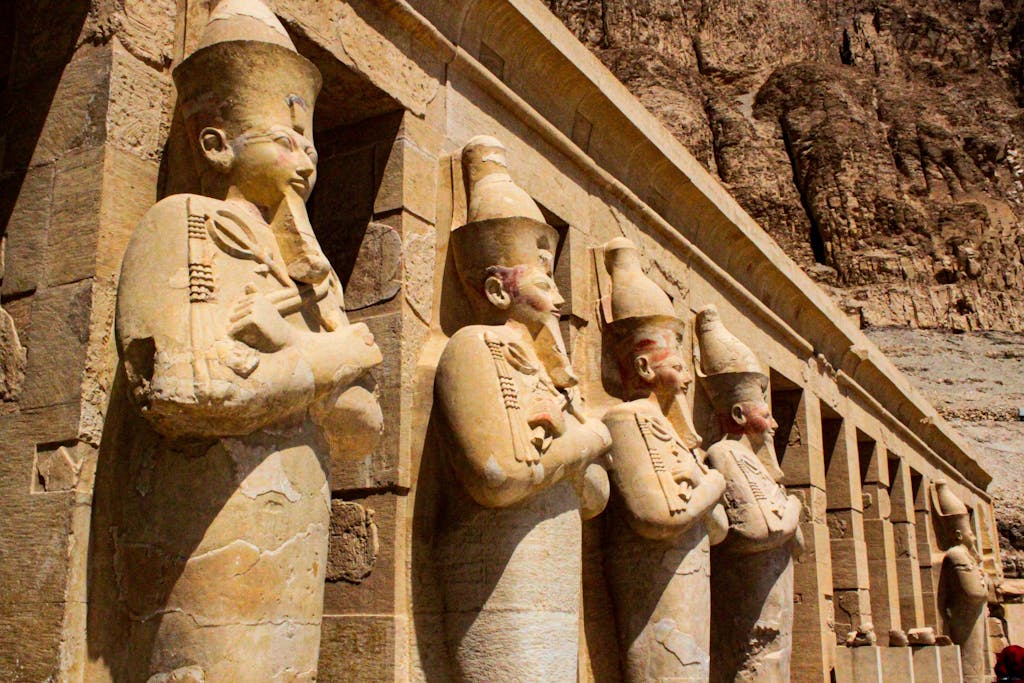 Row of ancient statues at the famous Hatshepsut Temple in Egypt.